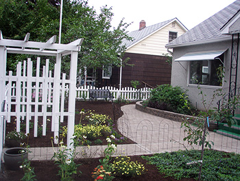 A wrought iron bench and oak barrel are added for decor
