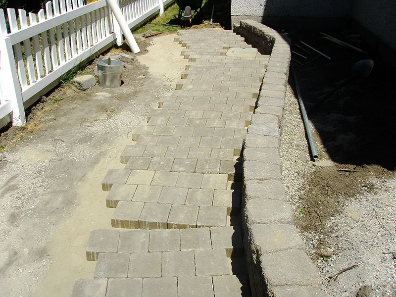 Brickwork replaces lawn along the side of the house